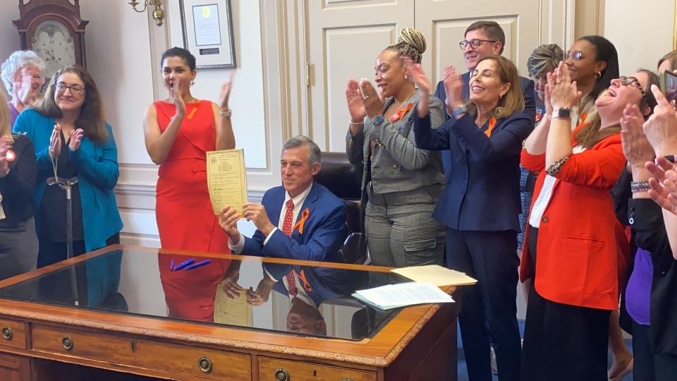Delaware Gov. John Carney signs a "permit to purchase" handgun bill into law on Thursday (May 16, 2024).