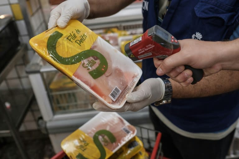 The staff of Rio de Janeiro state's consumer protection agency, PROCON, checks the temperature of frozen chicken products at a supermarket in Rio de Janeiro, Brazil, on March 24, 2017