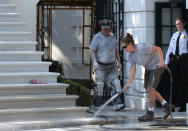 <p>A member of the National Park Service washes the new South Portico steps of the White House on Aug. 22, 2017 in Washington. (Photo: Alex Wong/Getty Images) </p>