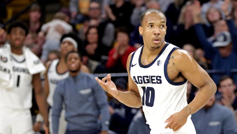 Utah State guard Darius Brown II celebrates after hitting a 3-pointer against East Tennessee State on Dec. 22, 2023, at the Spectrum in Logan.