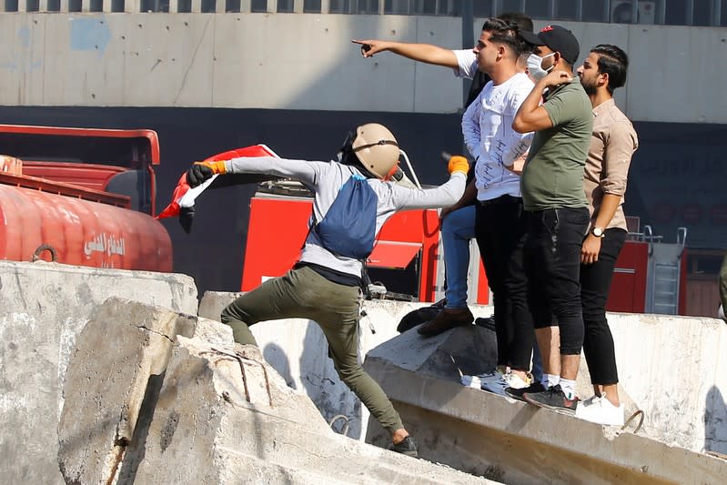 Demonstrators gesture during the ongoing anti-government protests in Baghdad