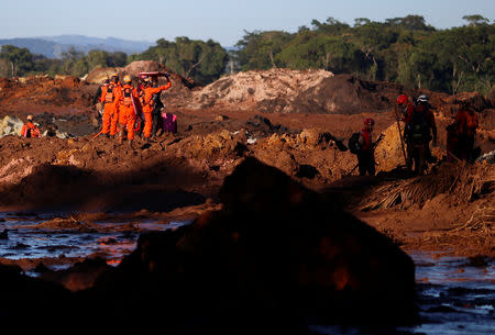 Members of a rescue team search for victims after a tailings dam owned by Brazilian mining company Vale SA collapsed, in Brumadinho, Brazil January 28, 2019. REUTERS/Adriano Machado