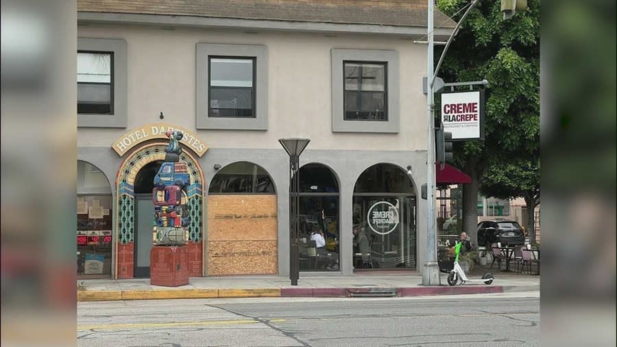 Shop windows were boarded up after a man went on a window-smashing spree in Long Beach's East Village neighborhood on June 6, 2024. (KTLA)