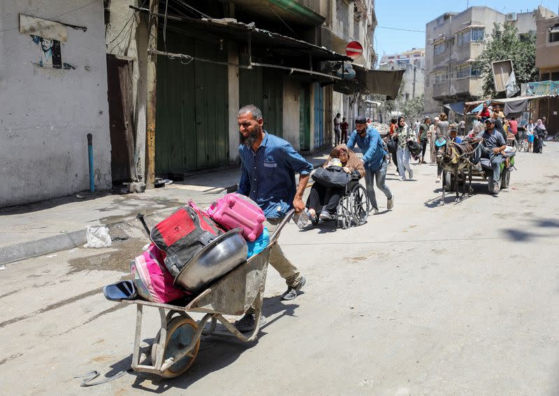 Palestinians flee their homes following an Israeli military operation in Shejaiya, amid Israel-Hamas conflict, in Gaza City