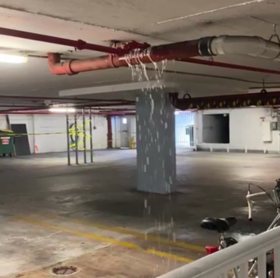 An image shows water leaking from a pipe in the Port Royale condo building’s lobby-level garage in mid-September.