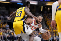 New York Knicks guard Jalen Brunson (11) drives around Indiana Pacers forward Aaron Nesmith (23) during the first half of Game 3 in an NBA basketball second-round playoff series, Friday, May 10, 2024, in Indianapolis. (AP Photo/Michael Conroy)