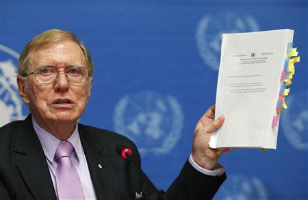 Michael Kirby, Chairperson of the Commission of Inquiry on Human Rights in North Korea, holds a copy of his report during a news conference at the United Nations in this file picture taken in Geneva February 17, 2014. REUTERS/Denis Balibouse/Files