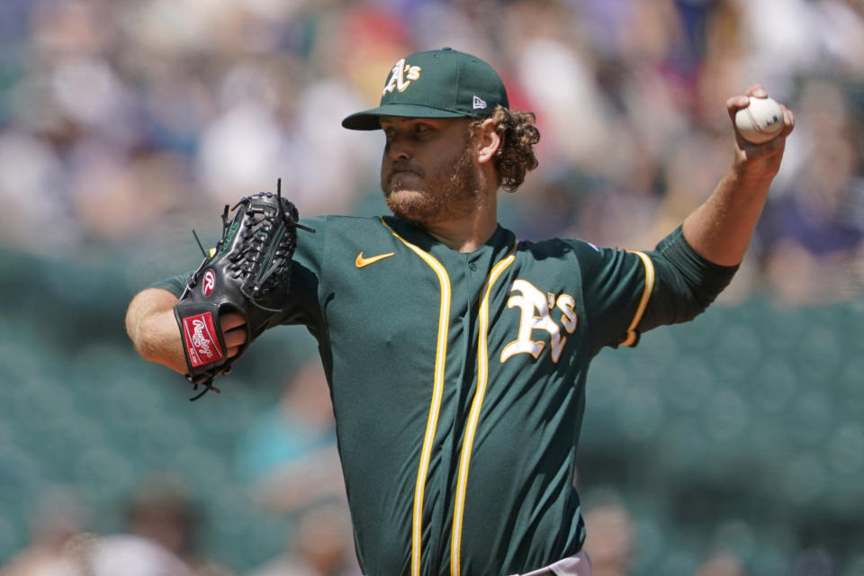 Oakland Athletics starting pitcher Cole Irvin throws against the Seattle Mariners during the first inning of a baseball game, Sunday, July 25, 2021, in Seattle. (AP Photo/Ted S. Warren)