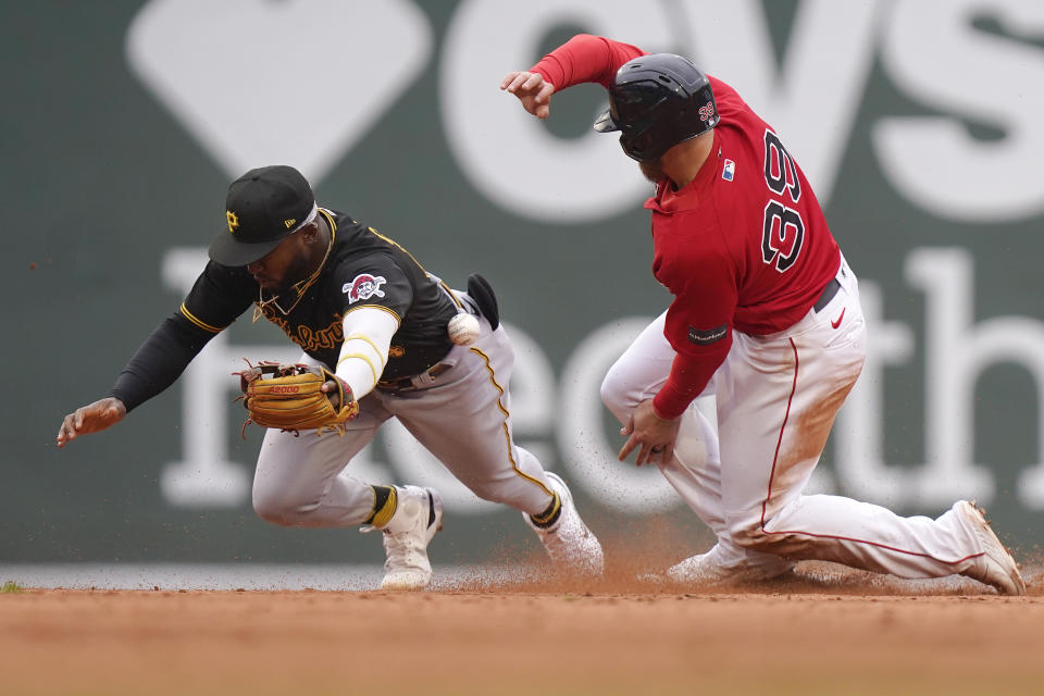 Pittsburgh Pirates' Rodolfo Castro, left, tries to get his glove on the ball as Boston Red Sox's Christian Arroyo, right, steals second base in the seventh inning of a baseball game, Wednesday, April 5, 2023, in Boston. (AP Photo/Steven Senne)