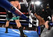 Dec 17, 2016; Los Angeles, CA, USA; Bernard Hopkins (red tape) is knocked out of the ring by Joe Smith Jr. (blue Tape) in the seventh round of their light heavyweight boxing fight at The Forum. Smith Jr. won with a TKO in round 7. Mandatory Credit: Jayne Kamin-Oncea-USA TODAY Sports