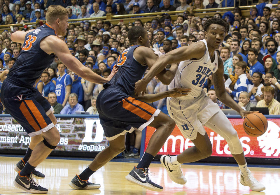 Duke’s Wendall Carter, Jr. (34) drives against the defense of Virginia’s Mamadi Diakite (25) and Jack Salt (33) during the first half of an NCAA college basketball game in Durham, N.C., Saturday, Jan. 27, 2018. (AP Photo/Ben McKeown)