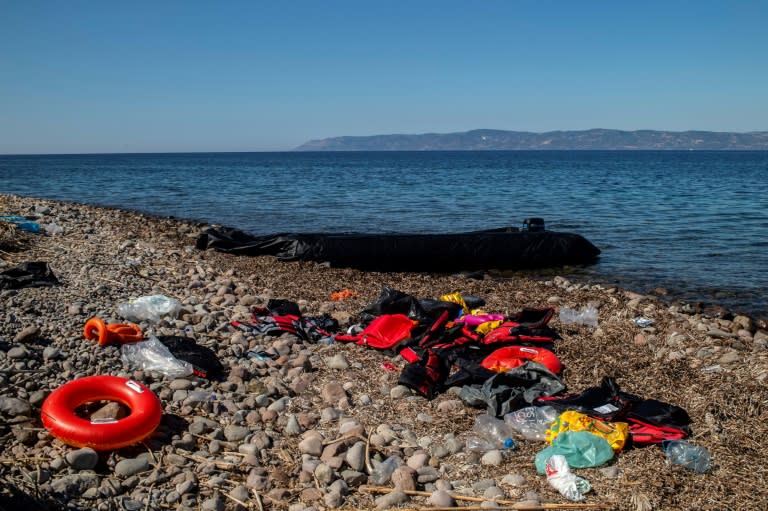 Life jackets used by refugees lie on a beach in Lesbos