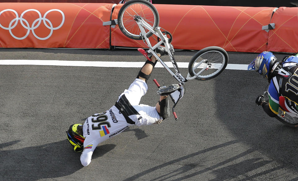 FILE - Colombia's Carlos Mario Oquendo Zabala crashes during a BMX cycling men's quarterfinal run at the 2012 Summer Olympics in London, Thursday, Aug. 9, 2012. The most dangerous event at the upcoming Paris Olympics might well be BMX, where broken bones, concussions and even paralysis occur with scary regularity. (AP Photo/Christophe Ena, File)