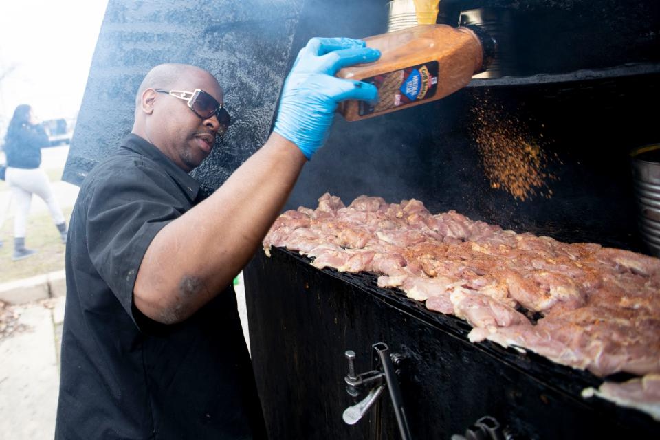 Kendrick Westbrook of Smurfey's Smokehouse seasons chicken in his smoker Sunday, March 15, 2020, during the fourth annual Soulful Food Truck Festival in Memphis.