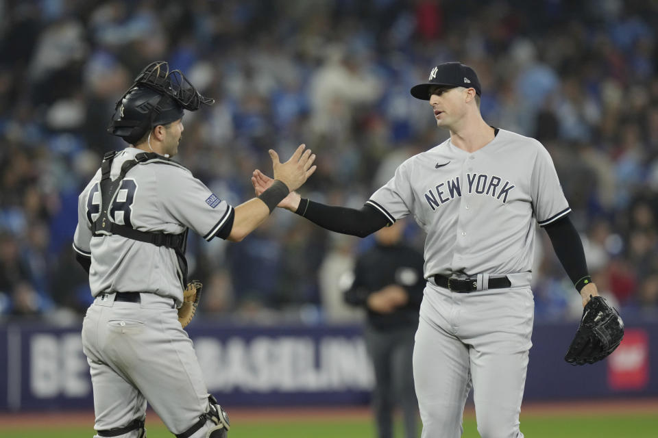 New York Yankees closing pitcher Clay Holmes, left, celebrates with catcher Austin Wells after their team's win in a baseball game against the Toronto Blue Jays in Toronto on Tuesday, Sept. 26, 2023. (Chris Young/The Canadian Press via AP)