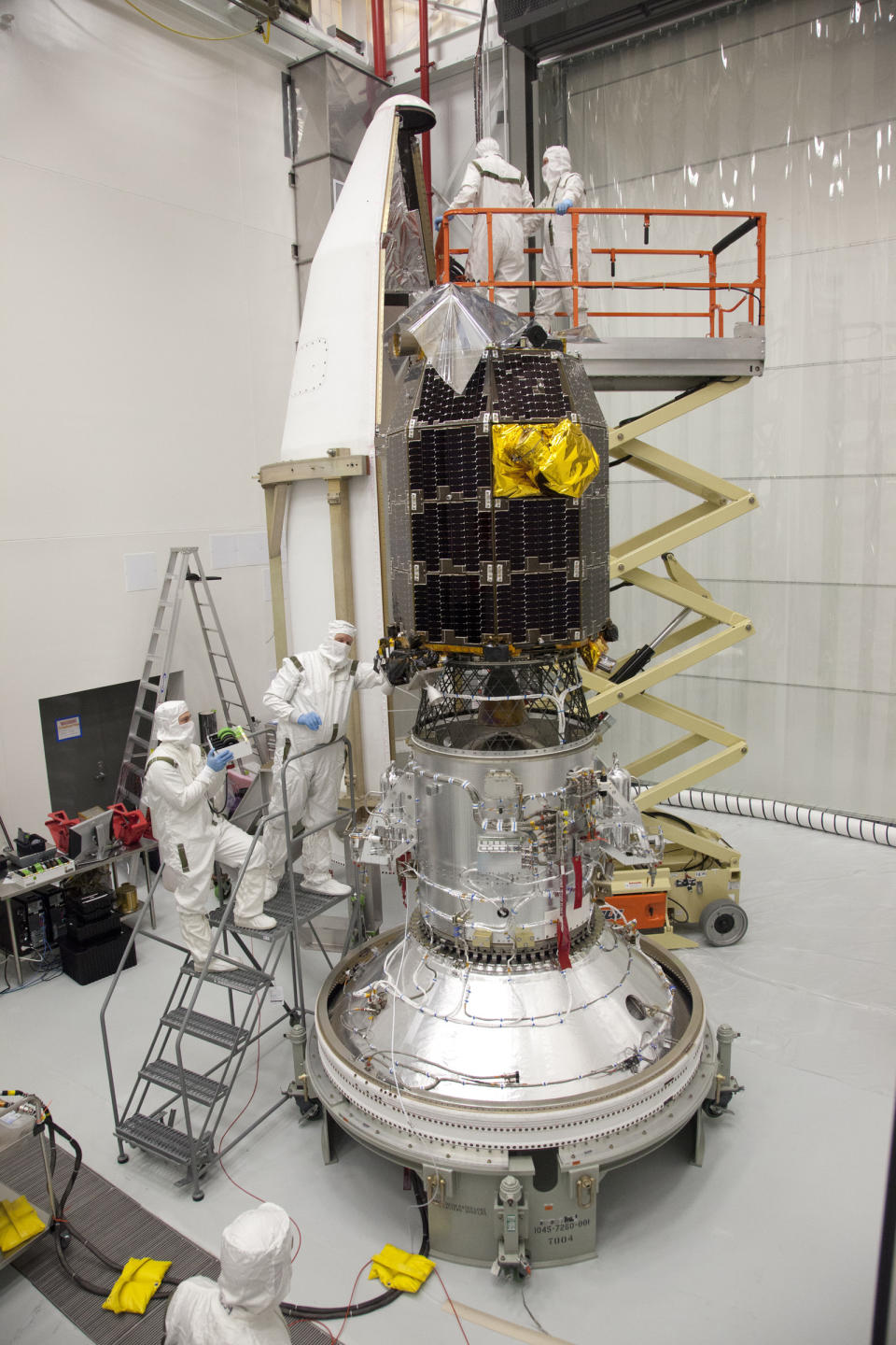 In this Aug. 20, 2013 photo provided by NASA, engineers prepare to install the Lunar Atmosphere and Dust Environment Explorer (LADEE) spacecraft into the fairing of the Minotaur V launch vehicle nose-cone at NASA's Wallops Flight Facility in Wallops Island, Va. On Friday, April 18, 2014, flight controllers confirmed that the orbiting spacecraft crashed into the back side of the moon as planned, just three days after surviving a full lunar eclipse, something it was never designed to do. During its $280 million mission, LADEE identified various components of the thin lunar atmosphere — neon, magnesium and titanium, among others — and studied the dusty veil surrounding the moon, created by all the surface particles kicked up by impacting micrometeorites. (AP Photo/NASA, Terry Zaperach)