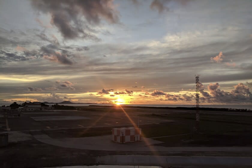 FILE - The sun sets over the runway at the Chuuk Airport in Weno, Federated States of Micronesia, on OCT. 28, 2017. In mid-July, 2022, Micronesia likely became the final nation in the world with a population of more than 100,000 to experience an outbreak of the disease, after avoiding it for two-and-a-half years thanks to its geographic isolation and border controls. (AP Photo/Nicole Evatt, File)