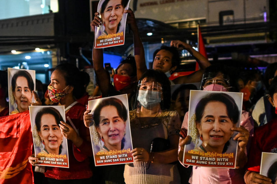 Supporters of the National League for Democracy (NLD) party hold posters with the image of Myanmar state counsellor Aung San Suu Kyi as supporters celebrate in front of the party's headquarters in Yangon on November 9, 2020, as NLD officials said they were confident of a landslide victory in the weekend's election.<span class="copyright">Ye Aung Thu—AFP/ Getty Images</span>