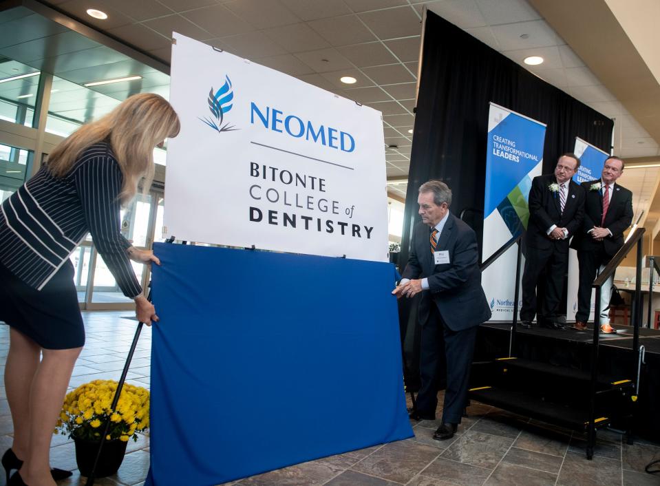 Brothers Gary and David Bitonte look on as Debbie Okey, chair NEOMED Foundation board of directors and Phil Trueblood, chair NEOMED board of trustees, unveil the official name, The Bitonte College of Dentistry , for the new NEOMED college.