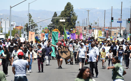 Protesters march from the intersection of Florence and Normandie Avenue, the flashpoint where the riots started 25 years ago, to a nearby park for a rally to remember and honor the victims of the 1992 Los Angeles riots in Los Angeles, California, U.S., April 29, 2017. REUTERS/Kevork Djansezian