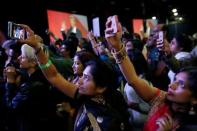 Attendees watch Republican presidential nominee Donald Trump speak at a Bollywood-themed charity concert put on by the Republican Hindu Coalition in Edison, New Jersey, U.S. October 15, 2016. REUTERS/Jonathan Ernst