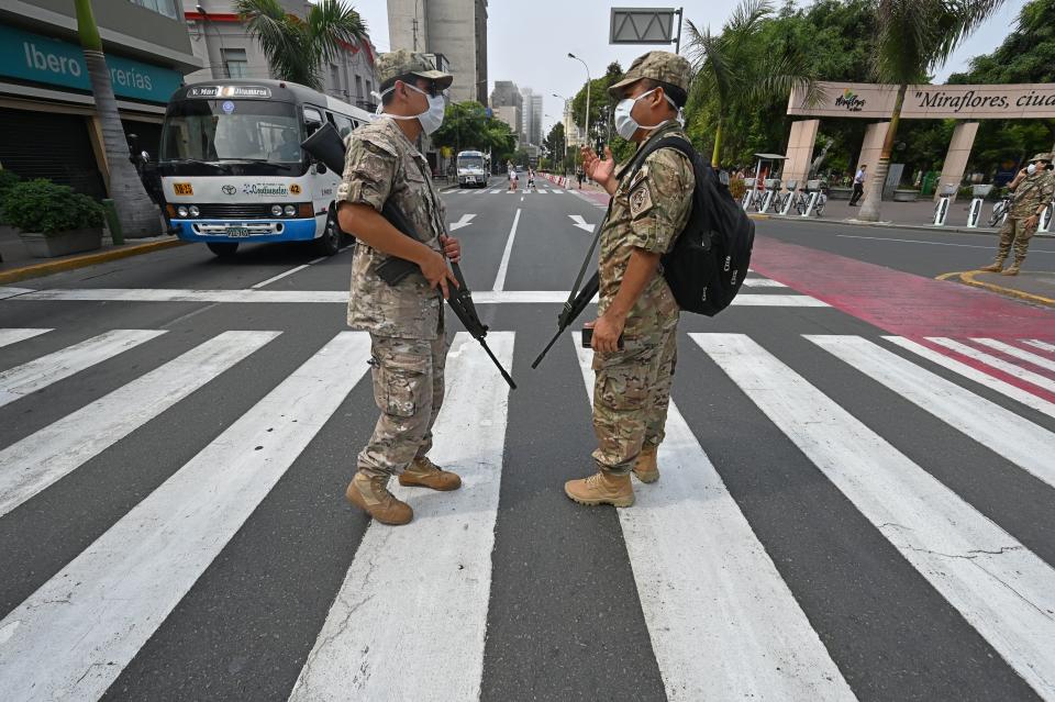 Peruvian army soldiers control traffic in Lima on March 16, 2020, in an attempt to persuade the population to stay at home, one day after President Martin Vizcarra announced a State of Emergency and a two-week nationwide home-stay quarantine. Source: Getty Images