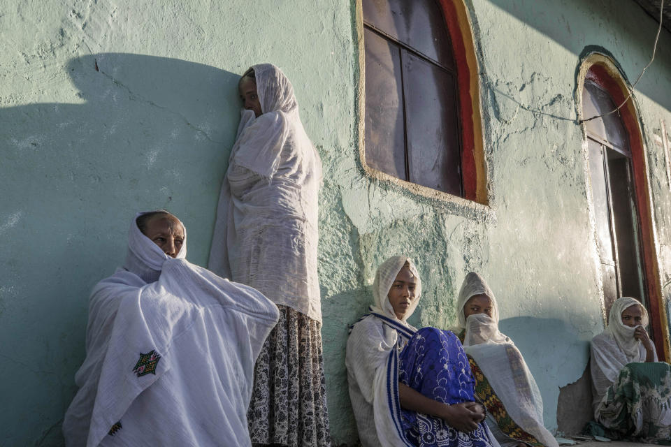 Tigrayan women who fled the conflict in Ethiopia's Tigray region, pray during Sunday Mass at a church, near Umm Rakouba refugee camp in Qadarif, eastern Sudan, Nov. 29, 2020. (AP Photo/Nariman El-Mofty)