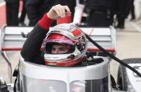 FILE - In this Feb. 12, 2020, file photo, IndyCar driver Will Power lowers into his car as he prepares to drive in IndyCar Series testing, in Austin, Texas. The 2020 IndyCar season will open Saturday night, June 6, at Texas Motor Speedway. An already lengthy offseason has been stretched to more than eight months since IndyCar last raced and the first event back is at Texas' high-speed oval where drivers will get their first test of a heavy new windshield designed to protect the cockpit. (AP Photo/Eric Gay, File)