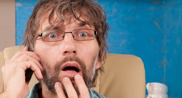 mature man sitting in chair with mobile phone