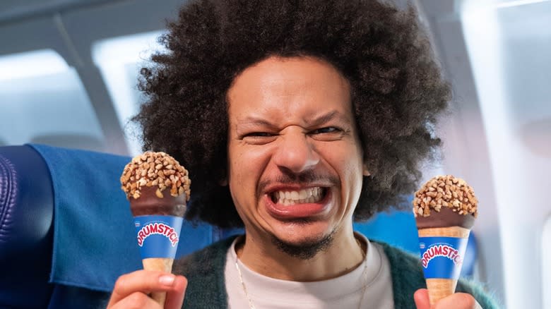 Eric André with a Drumstick in each hand