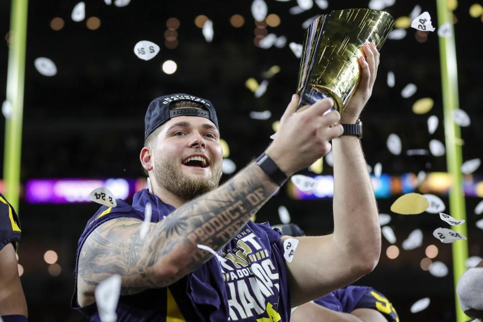 Michigan offensive lineman Zak Zinter celebrate 34-13 win over Washington at the national championship game at NRG Stadium in Houston on Monday, Jan. 8, 2024.