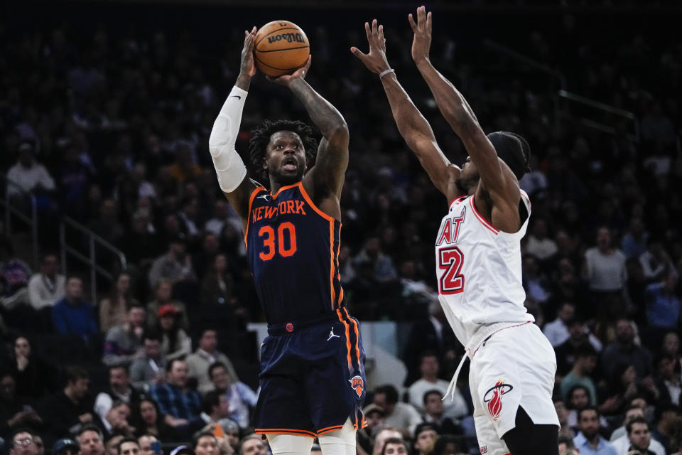 New York Knicks' Julius Randle, left, shoots over Miami Heat's Jimmy Butler during the second half of an NBA basketball game Thursday, Feb. 2, 2023, in New York. (AP Photo/Frank Franklin II)