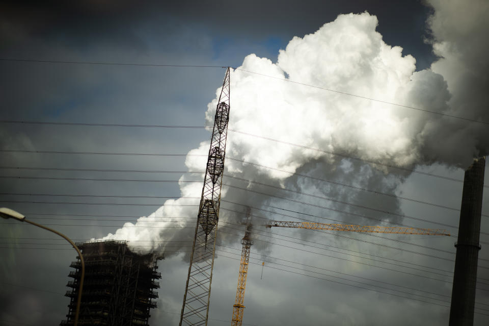 28 August 2020, North Rhine-Westphalia, Duisburg: Steam comes from an extinguishing system on the site of the Thyssenkrupp steelworks, while a construction crane and a power line are on display. ThyssenKrupp aims to achieve climate-neutral steel production by 2050. One step toward this goal will be the switch to direct reduction plants, which in the future will be operated with green hydrogen. The first such plant from Thyssenkrupp is scheduled to start operation at the Duisburg site in the mid-2020s. The project plan for this will be handed over to Altmaier on schedule. Photo: Jonas Güttler/dpa (Photo by Jonas Güttler/picture alliance via Getty Images)