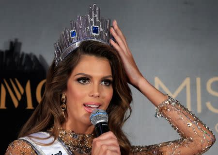 Newly-crowned Miss Universe Iris Mittenaere from France holds on to her crown during a news conference inside a Mall of Asia arena in metro Manila, Philippines January 30, 2017. REUTERS/Romeo Ranoco