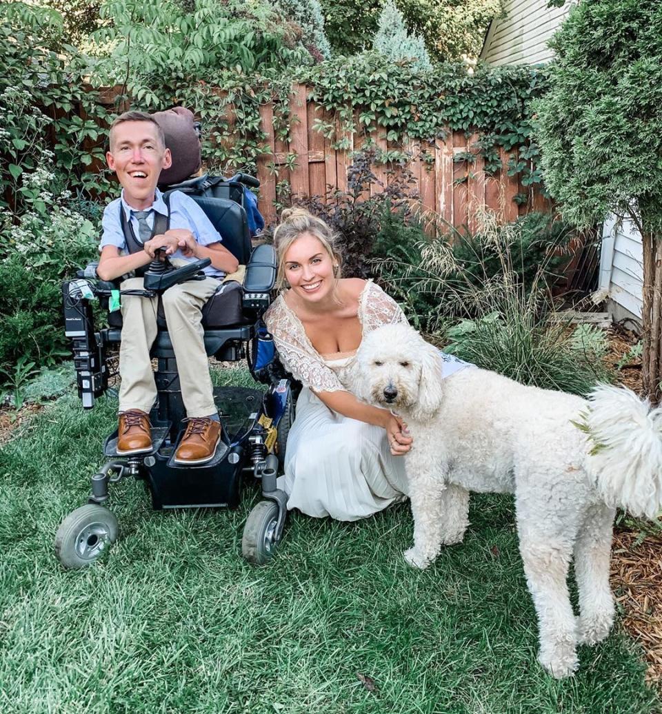 Shane Burcaw and Hannah Aylward, with their dog on their wedding day