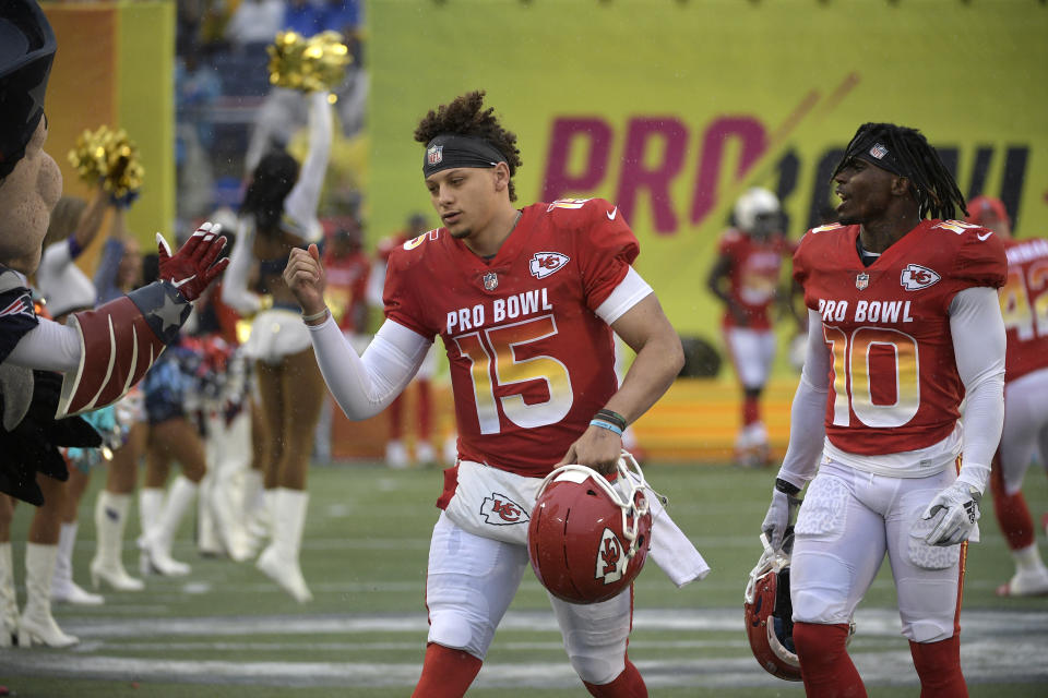 AFC quarterback Patrick Mahomes (15) and wide receiver Tyreek Hill (10), of the Kansas City Chiefs, run onto the field during player introductions before the NFL Pro Bowl football game against the NFC Sunday, Jan. 27, 2019, in Orlando, Fla. (AP Photo/Phelan M. Ebenhack)