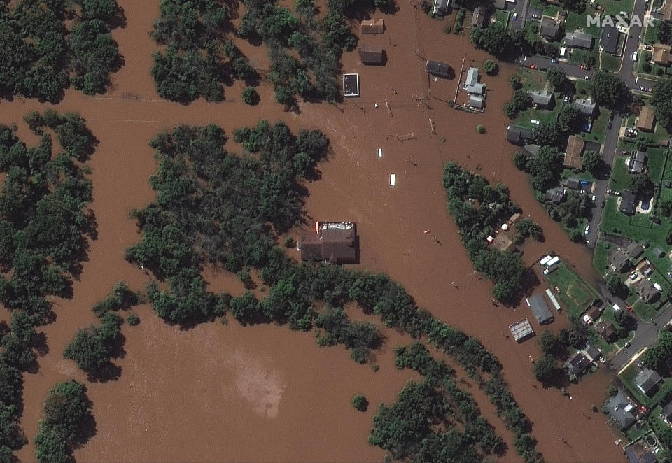 In a satellite image provided by Maxar Technologies, the Saffron Banquet Hall in Manville, N.J. is surrounded by floodwaters Thursday, Sept. 2, 2021, after remnants of Hurricane Ida swept through the area (Satellite image ©2021 Maxar Technologies via AP)