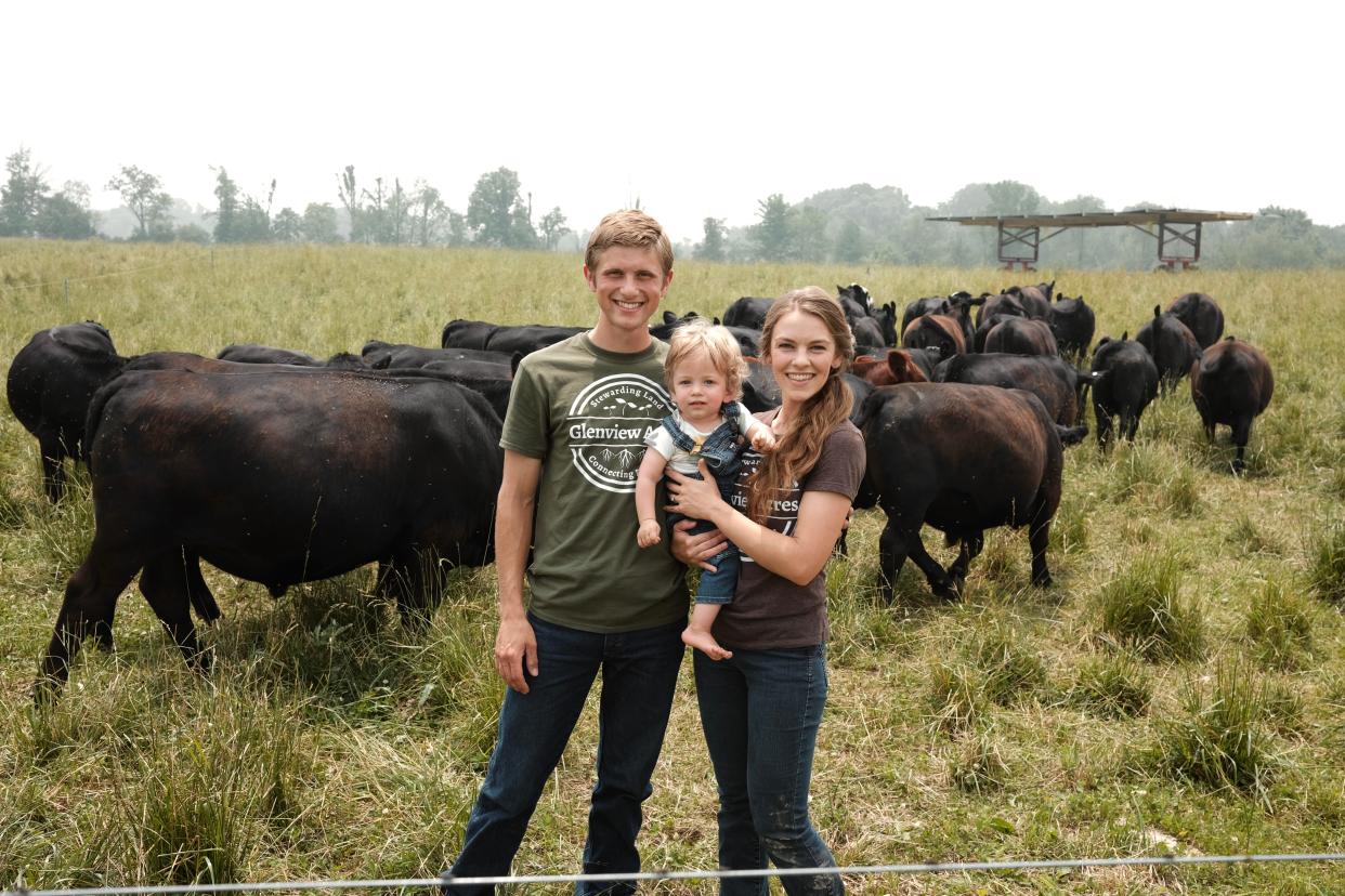 Joe and Jen Lautzenheiser run Glenview Acres, a pasture-based farm in Tuscarawas Township. Here they are with son Travis among a herd of cattle.