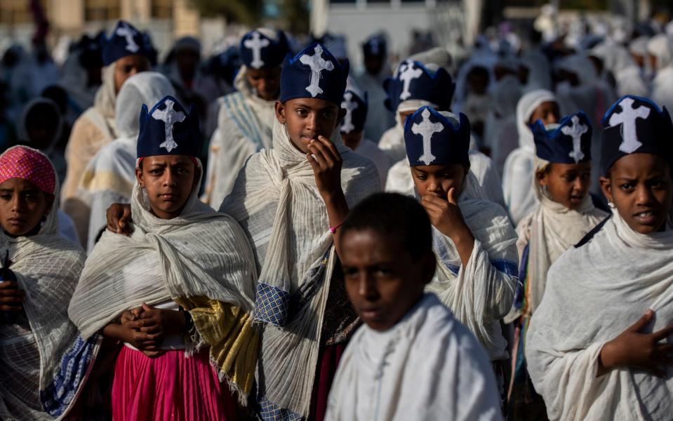 Young members of the choir walk amongst congregants during a Sunday morning service of the Ethiopian Orthodox Tewahedo Church at the Church of St. Mary in Mekele, in the Tigray region of northern Ethiopia - Ben Curtis /AP