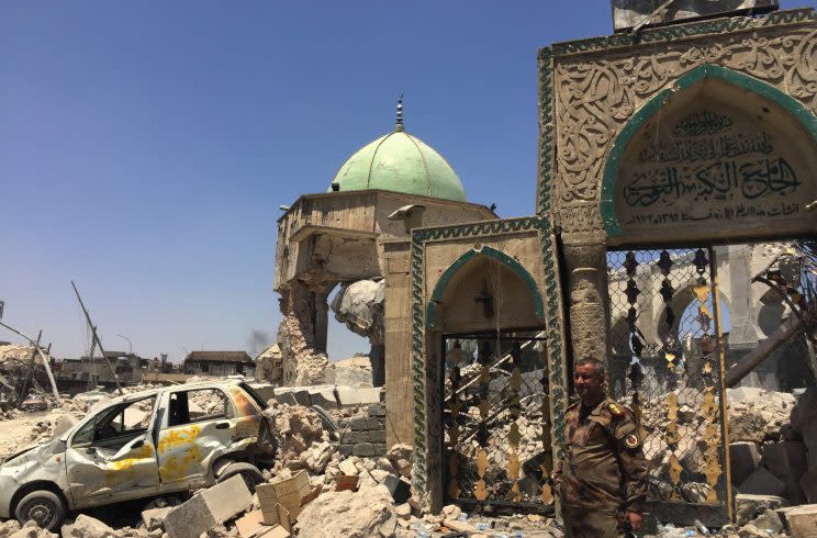 A Iraqi forces soldier stands outside the remains of the Great Mosque of al-Nuri, blown up weeks ago. (Ash Gallagher for Yahoo News)