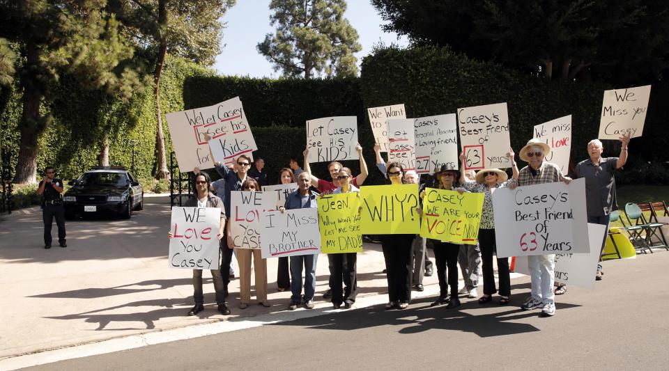 In this Oct. 1, 2013 photo, friends and family of veteran radio personality Casey Kasem stage a protest outside his home in Beverly Hills, Calif. Kasem's children from a former marriage, his brother and friends who want to see him have have been denied any contact with him by his current wife, Jean Kasem. The three adult children of the radio host have filed a legal petition for conservatorship on Monday, Oct. 7, 2013, to gain control of his health care. (Photo by Todd Williamson/Invision/AP)