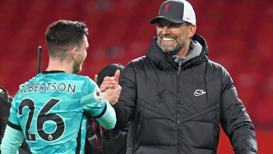 Seen here, Jurgen Klopp shakes hands with Liverpool defender Andy Robertson.