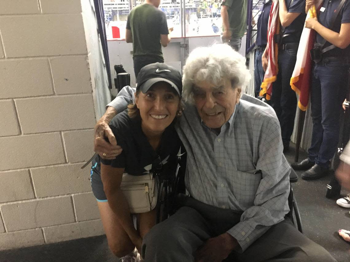 Anna Salton Eisen, left, visits with decorated veteran James Megellas in 2018 at a fundraiser for veterans in North Richland Hills. Megellas, who died in 2020 at age 103, will be laid to rest Friday at Arlington National Cemetery.