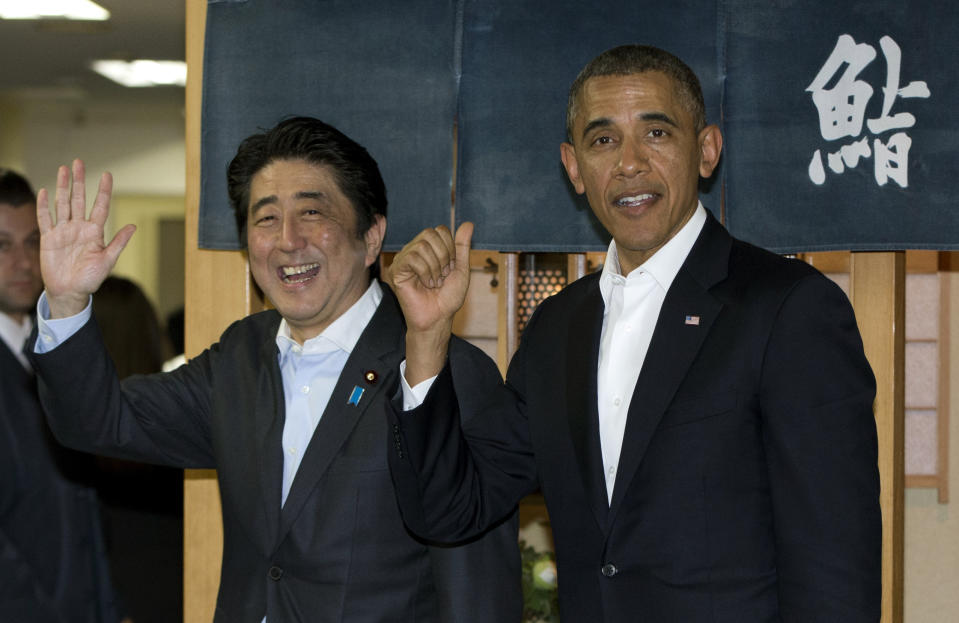 FILE - Then President Barack Obama and then Japanese Prime Minister Shinzo Abe depart Sukiyabashi Jiro sushi restaurant in Tokyo, Wednesday, April 23, 2014. Former Japanese Prime Minister Abe, a divisive arch-conservative and one of his nation's most powerful and influential figures, has died after being shot during a campaign speech Friday, July 8, 2022, in western Japan, hospital officials said. (AP Photo/Carolyn Kaster, File)