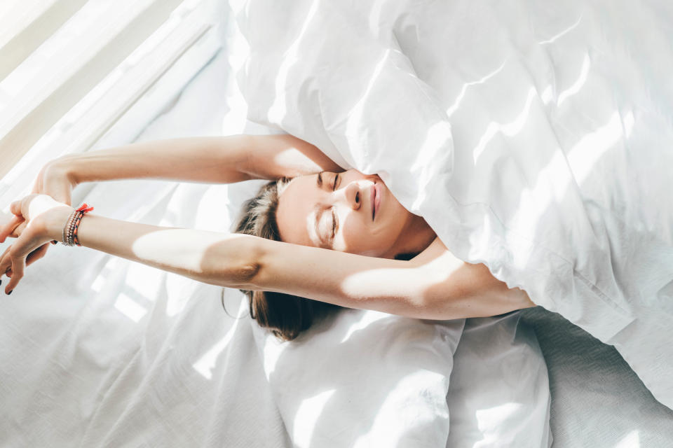 Woman sleeping under duvet