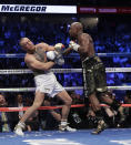 <p>Floyd Mayweather Jr. hits Conor McGregor in a super welterweight boxing match Saturday, Aug. 26, 2017, in Las Vegas. (AP Photo/Isaac Brekken) </p>