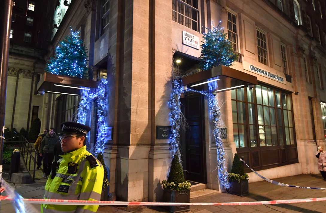 <em>Police outside the Grosvenor House Suites in Park Lane, London after a security guard was stabbed to death (PA)</em>