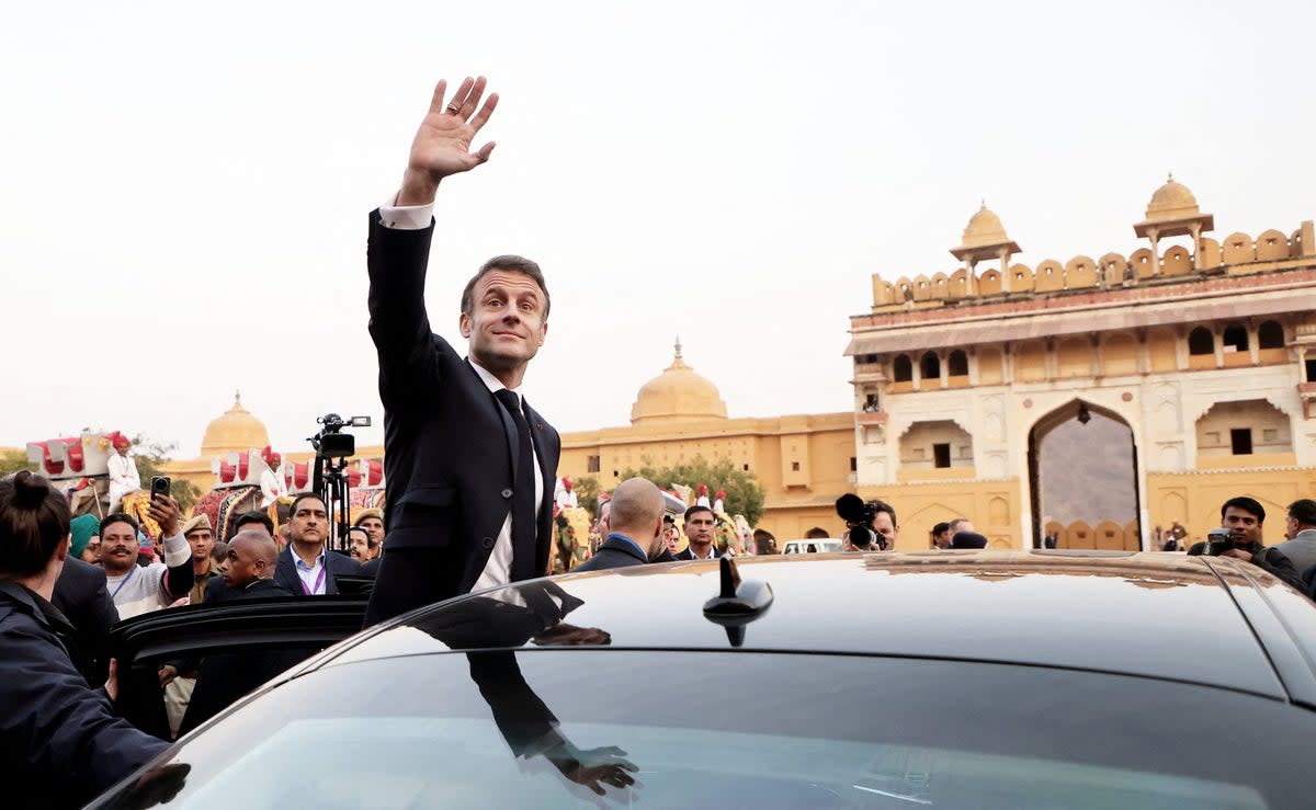 French President Emmanuel Macron waves as he attends a welcoming ceremony at Amber Fort in Jaipur (POOL/AFP via Getty Images)