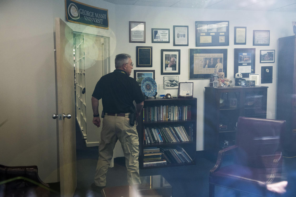 A law enforcement officer surveys the office of Rep. Gerry Connelly, D-Va., in Fairfax, Va., Monday.