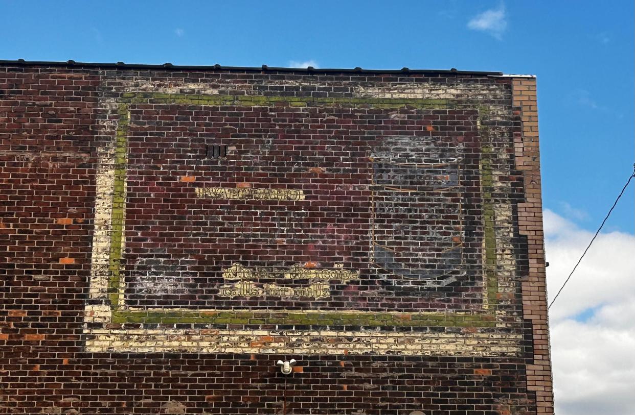 What was once a vibrant advertisement for Borden's evaporated milk is now barely distinguishable along a structure at West 6663 Fort Street.